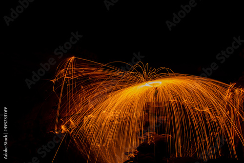 Iron wool at night, streaks of fire hit the rocks.
