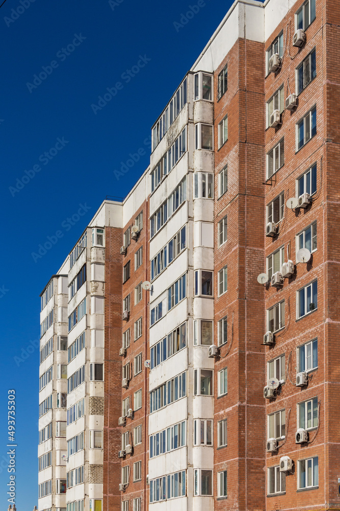 Multi-storey apartment brick house in Kazakhstan, red brick house facade with white balconies