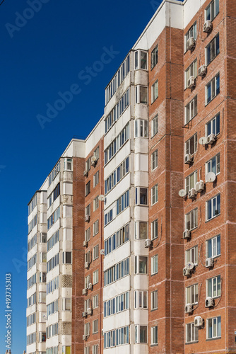 Multi-storey apartment brick house in Kazakhstan, red brick house facade with white balconies