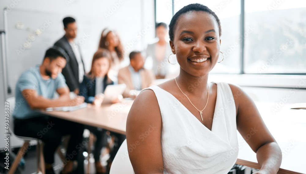 My seat at this table is guaranteed. Cropped portrait of an attractive young businesswoman attending a meeting in the boardroom with her colleagues in the background. My seat at this table is guaranteed. Cropped portrait of an attractive young businesswoman attending a meeting in the boardroom with her colleagues in the background.