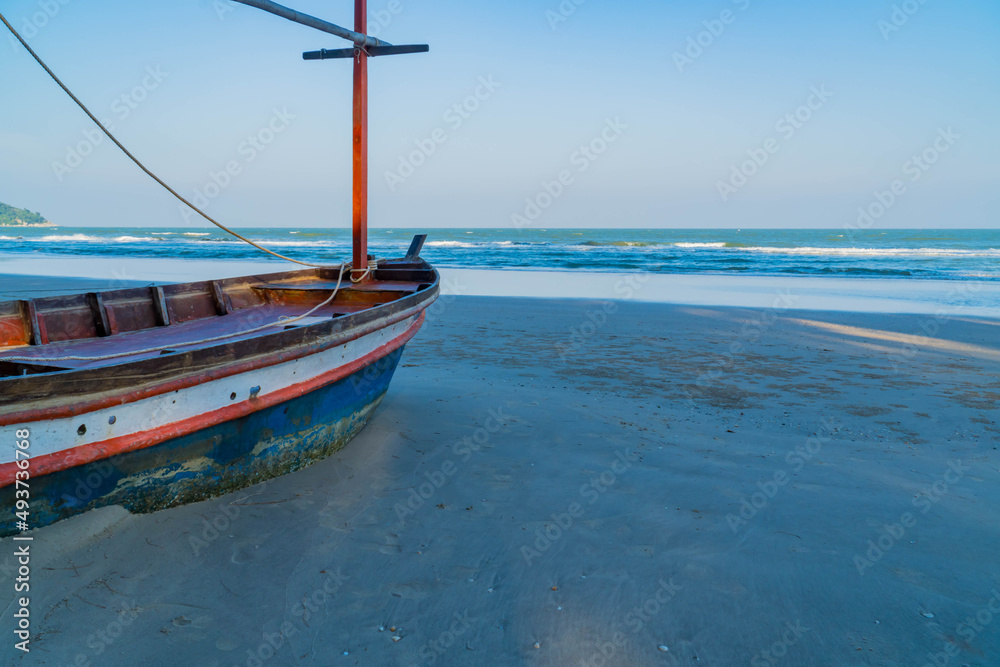 An old fishing boat on the beach with sea background. sea coast line. copy space for text.