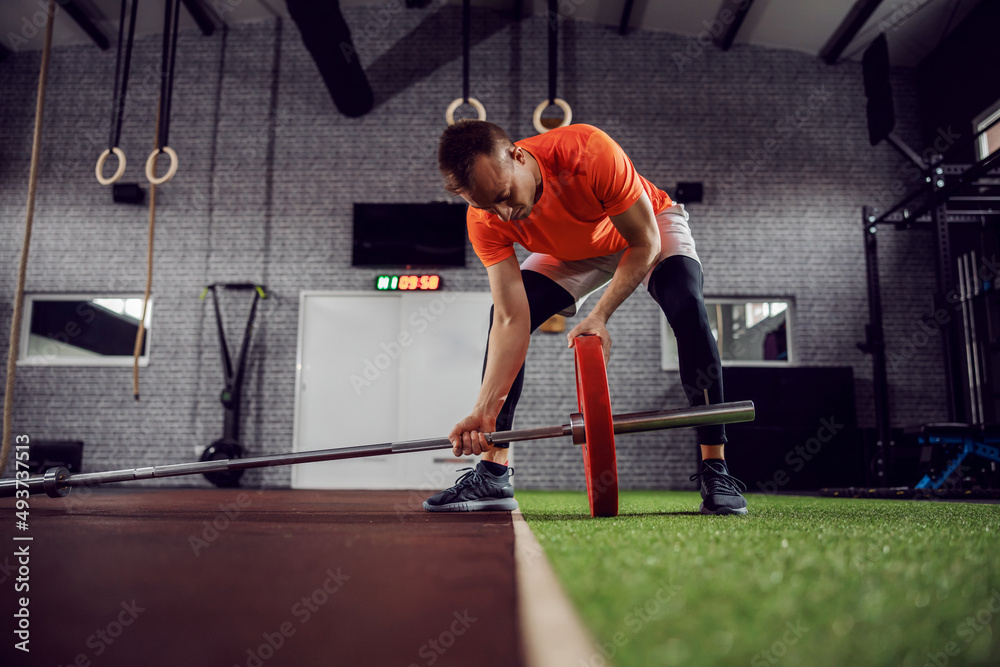 Preparing barbell weight for strong muscle burning training. Preparing barbell weight for strong muscle burning training.