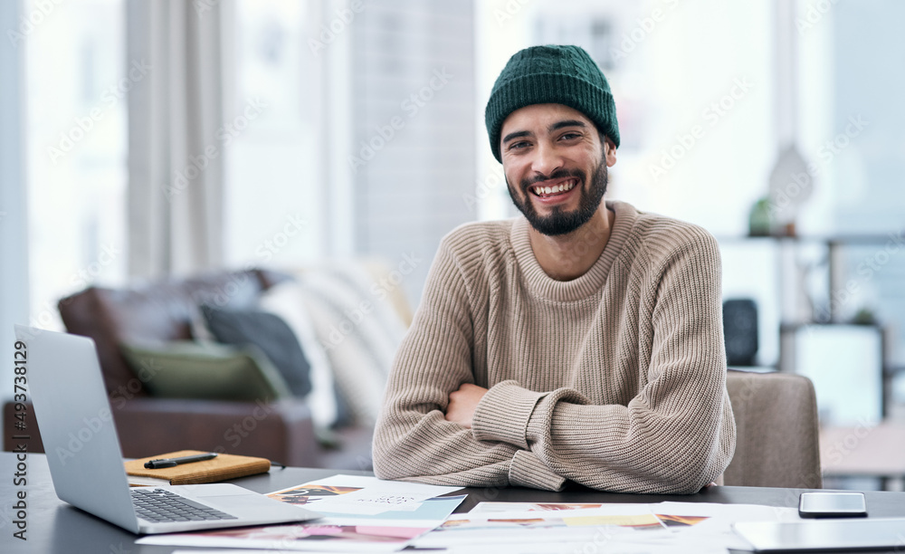 I create my own hours and my own paycheque. Portrait of a confident young man working from home. I create my own hours and my own paycheque. Portrait of a confident young man working from home.