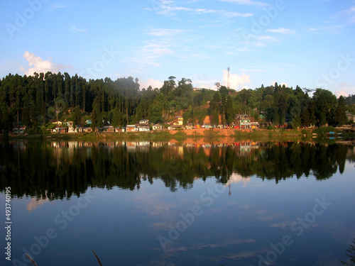 The conifer pine trees and houses mirrored at Sumendu Lake look mesmerizing at Mirik in Darjeeling. This is an old artificial lake measuring around 1.25 km long and main attraction of the place.