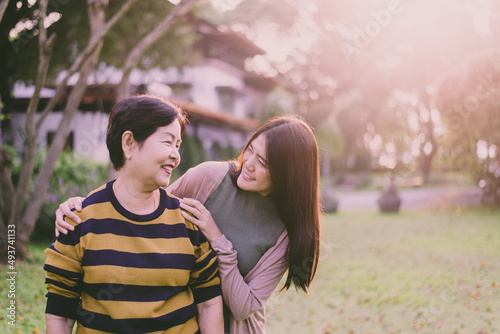 Asian elderly mother happy with hand daughter take care and support at outdoor,Health insurance and elderly care,Family caregiving concept