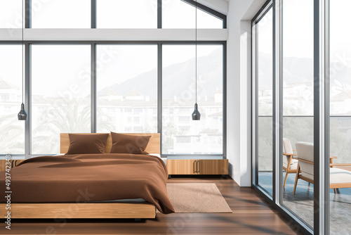 Front view on bright bedroom interior with bed, panoramic window © ImageFlow