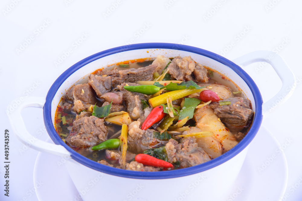 Thai favorite food. Spicy chicken soup (Tom Yum Gai Baan) in the white bowl. Thai favorite food. Spicy chicken soup (Tom Yum Gai Baan) in the white bowl.