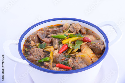 Thai favorite food. Spicy chicken soup (Tom Yum Gai Baan) in the white bowl.