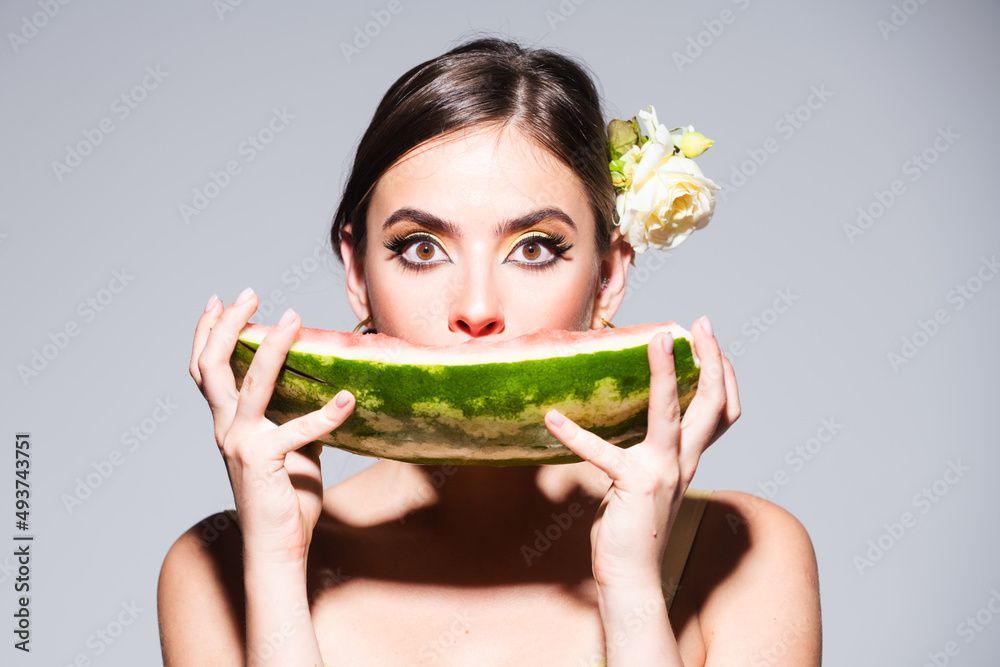 Closeup portrait of young sensual hispanic or italian woman eating watermelon isolated on gray background. Closeup portrait of young sensual hispanic or italian woman eating watermelon isolated on gray background.