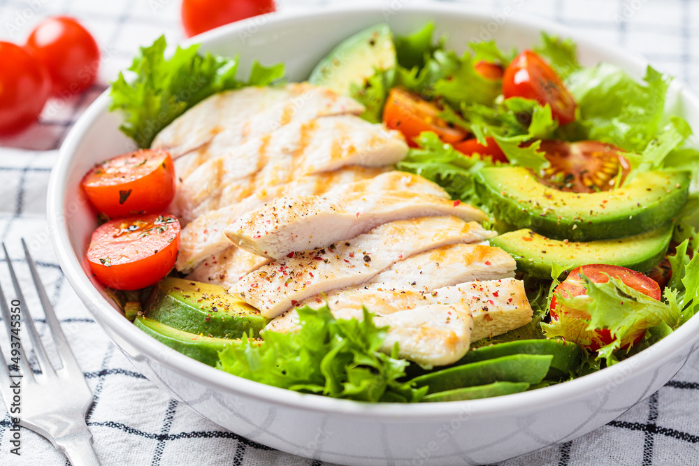Grilled chicken breast salad with avocado and cherry tomatoes. Healthy diet food concept. Grilled chicken breast salad with avocado and cherry tomatoes. Healthy diet food concept.