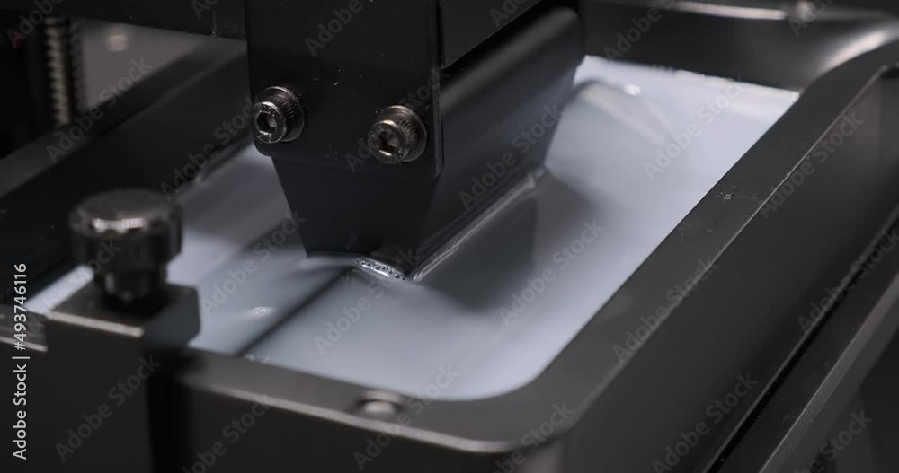 MSLA 3D printer, consumer resin 3d printer build plate moving up and down in resin vat. 3D printer. MSLA 3D printer, consumer resin 3d printer build plate moving up and down in resin vat. 3D printer.