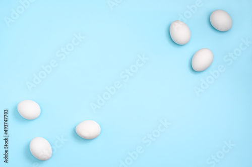 White eggs on pastel blue background 