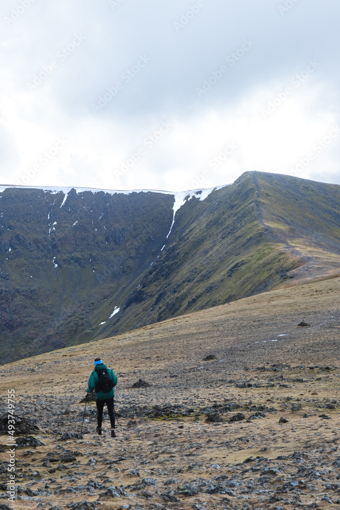 A walker heading towards Lower Man and Helvellyn in the Lake District