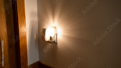 Night light plugged into a wall in a house