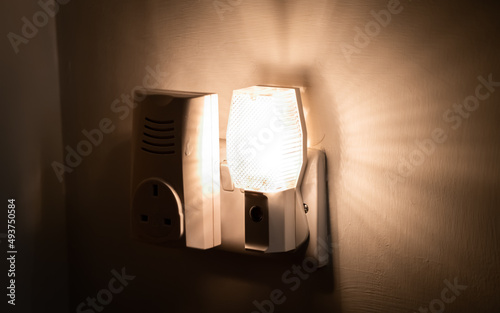 Close up of a night light plugged into a wall in a house