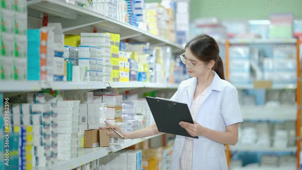 beautiful Asian pharmacist is checking products in a modern Pharmacy. which is a retail store with a large number of products
beautiful Asian pharmacist is checking products in a modern Pharmacy. which is a retail store with a large number of products
