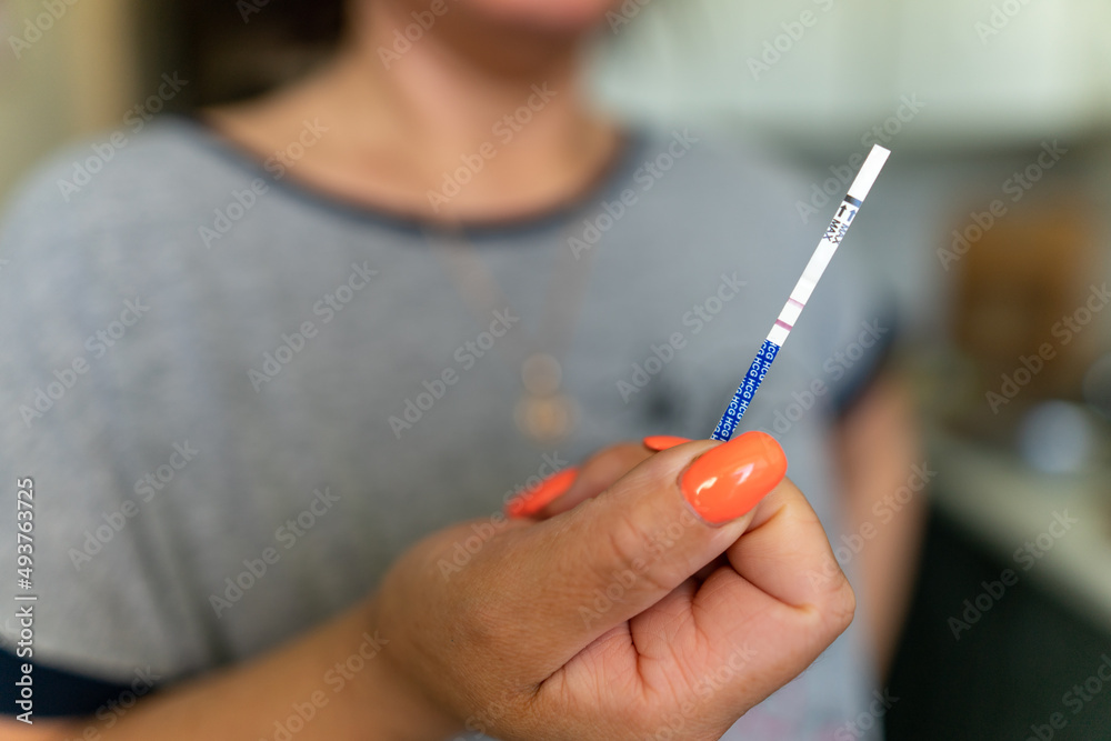 Pregnancy test in the hands of a girl with two strips Pregnancy test in the hands of a girl with two strips