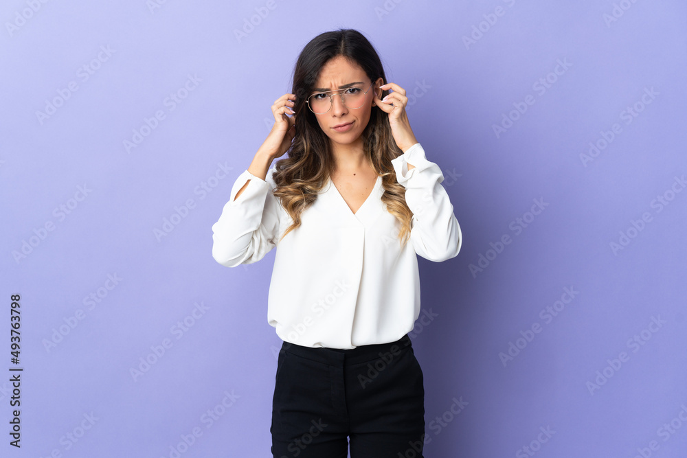 Young caucasian woman isolated on purple background frustrated and covering ears Young caucasian woman isolated on purple background frustrated and covering ears