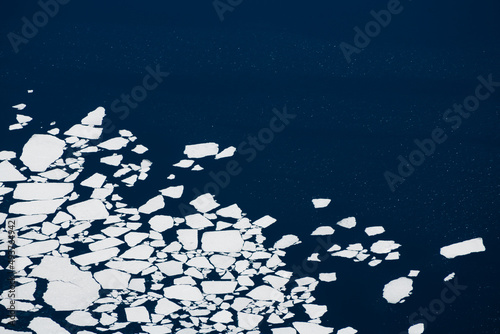 Fototapeta Naklejka Na Ścianę i Meble -  Melting ice on the lake. Abstract nature background. Aerial drone view. Baikal lake, Siberia, Russia. Beautiful spring landscape