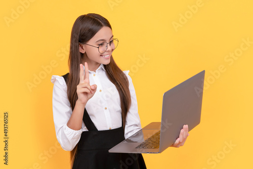 kid in glasses. teen girl use laptop for communication. modern education. back to school. photo