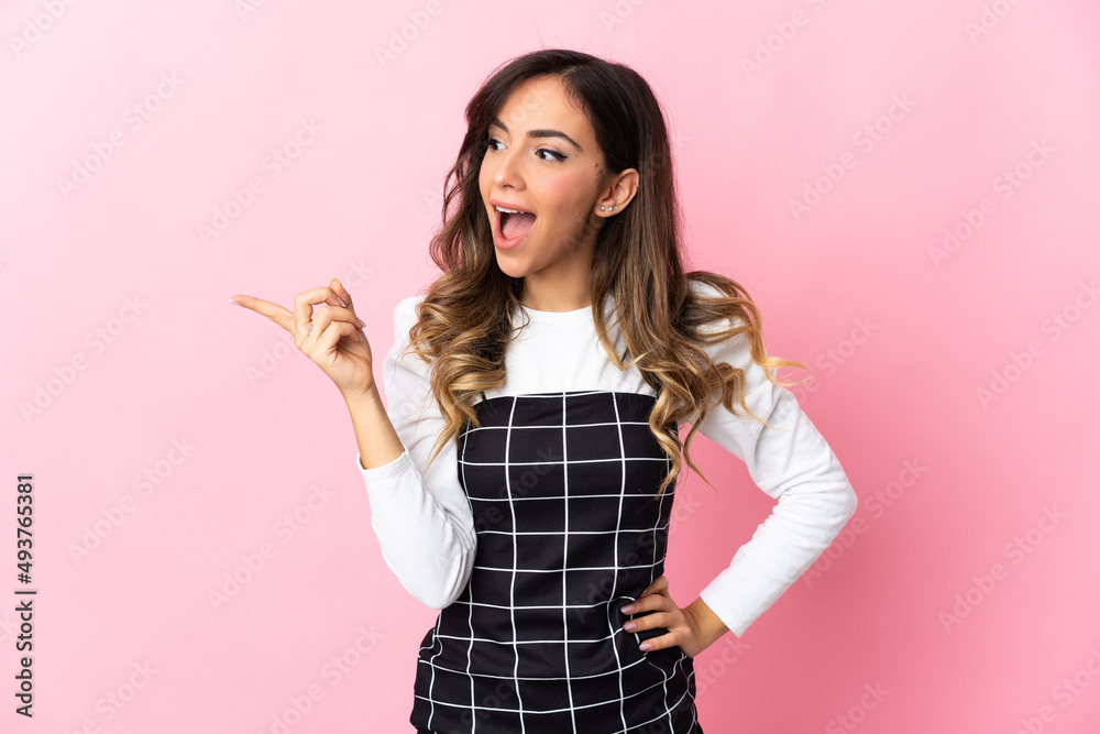 Young caucasian woman isolated on pink background intending to realizes the solution while lifting a finger up Young caucasian woman isolated on pink background intending to realizes the solution while lifting a finger up