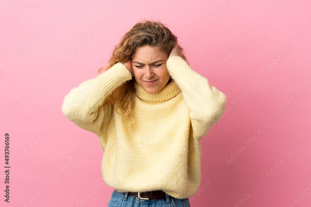 Young blonde woman isolated on pink background frustrated and covering ears Young blonde woman isolated on pink background frustrated and covering ears