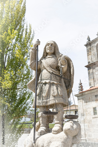 statue of Saint Michael the Archangel in front of the church at Mezio village, Castro Daire, district of Viseu, Portugal photo