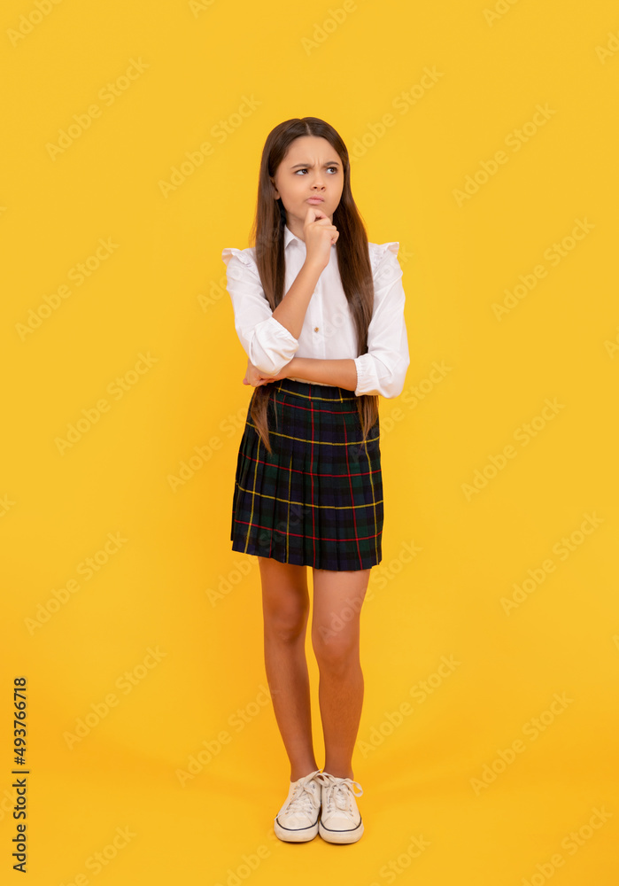 pondering child in school uniform full length on yellow background, ponder pondering child in school uniform full length on yellow background, ponder