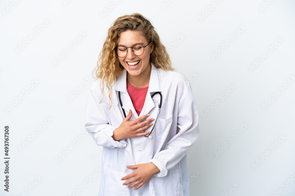 Young doctor blonde woman isolated on white background smiling a lot Young doctor blonde woman isolated on white background smiling a lot