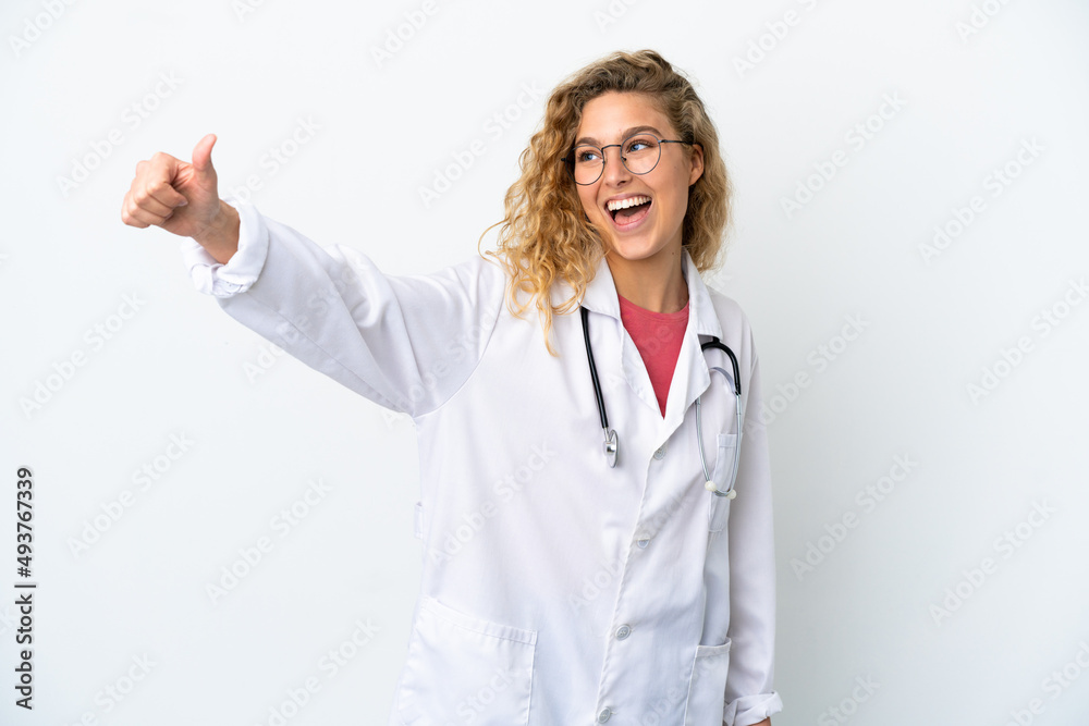 Young doctor blonde woman isolated on white background giving a thumbs up gesture