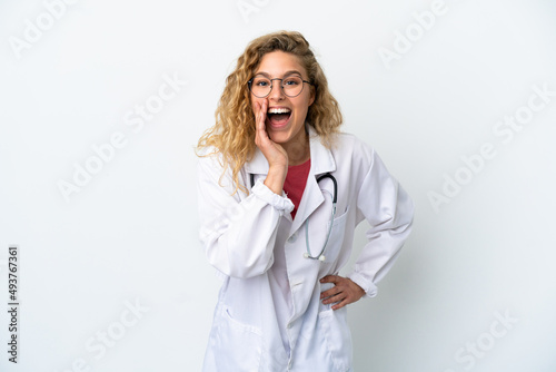 Young doctor blonde woman isolated on white background shouting with mouth wide open