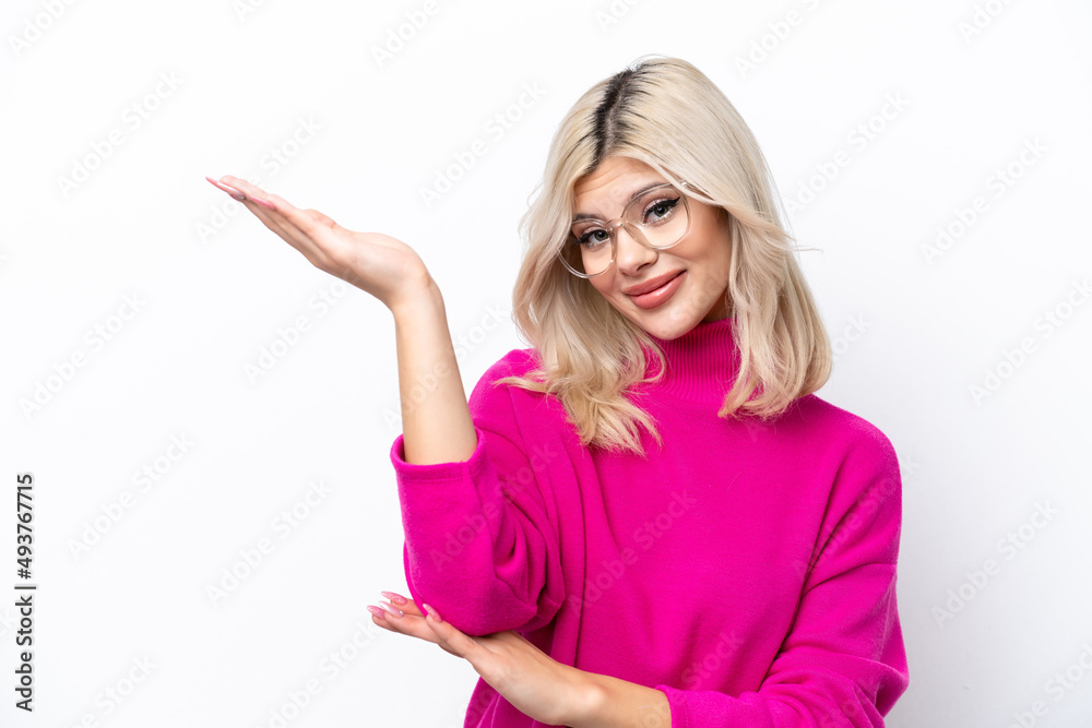 Young Russian woman isolated on white background extending hands to the side for inviting to come Young Russian woman isolated on white background extending hands to the side for inviting to come
