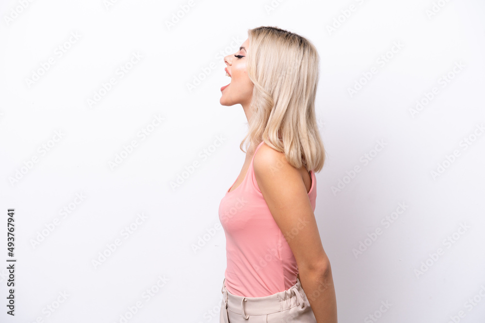 Young Russian woman isolated on white background laughing in lateral position Young Russian woman isolated on white background laughing in lateral position