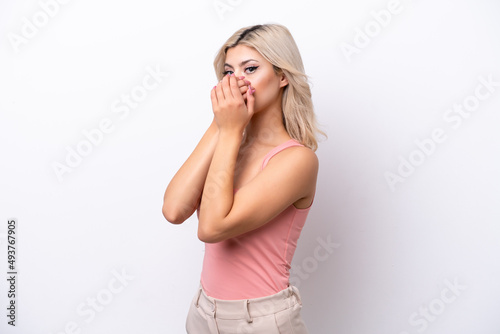 Young Russian woman isolated on white background covering mouth and looking to the side
