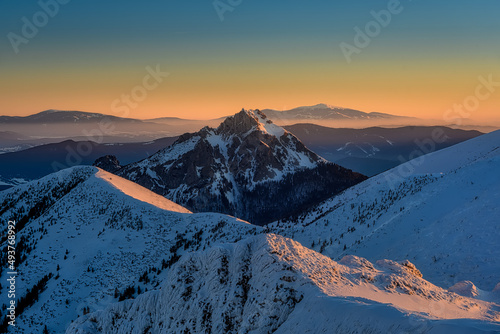 view at Velky Rozsutec in Mala Fatra on snowy slopes during sunrise photo