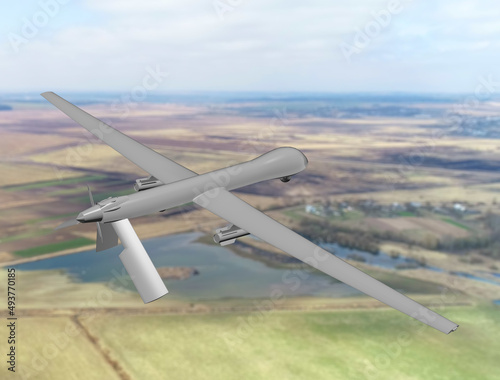 Military combat reconnaissance drone armed with missiles on the background of a natural landscape, top view. 3d render.