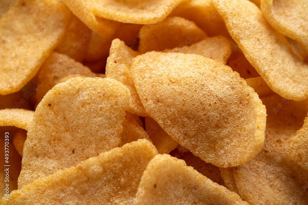 Crispy Prawn Crackers in white bowl on wooden table Crispy Prawn Crackers in white bowl on wooden table