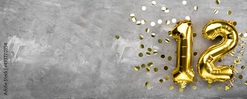 Принти на полотні Yellow foil balloon number, number twelve on a concrete background