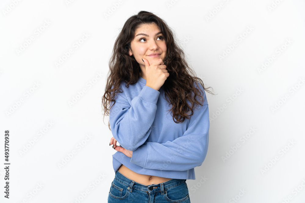 Teenager Russian girl isolated on white background thinking an idea while looking up Teenager Russian girl isolated on white background thinking an idea while looking up