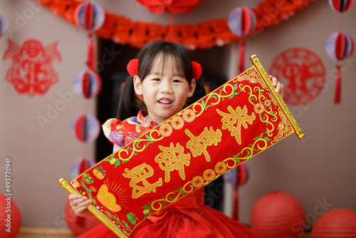 Canvas Print young Chinese girl with traditional dressing up holding kung hei fat choy gree