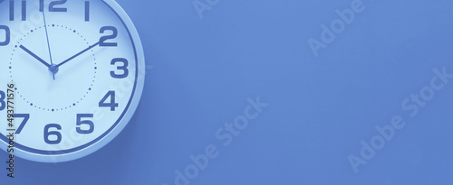 Clock on a purple background, the concept of time management, time planning. Web banner, free space.