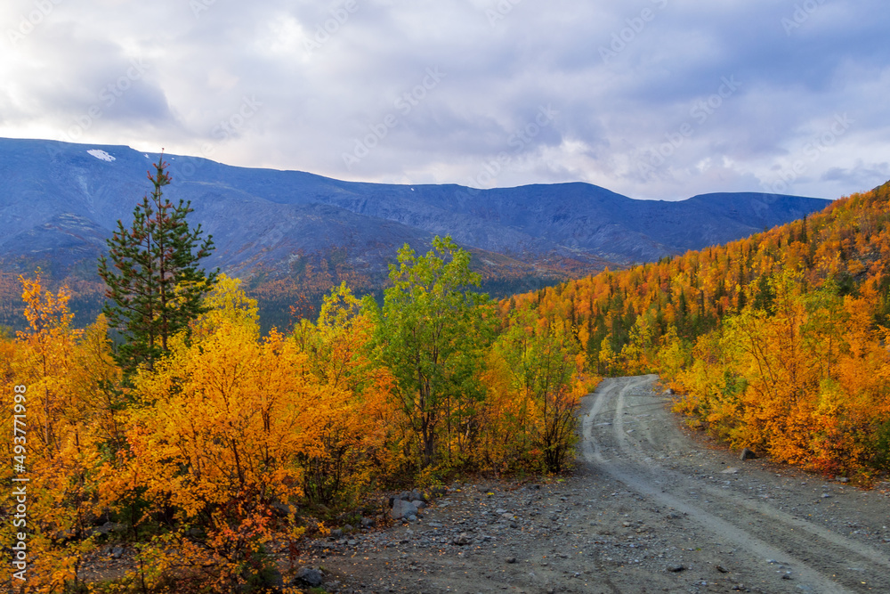 Dirt gravel road with mountains in the background. Autumn mountains of Khibiny Dirt gravel road with mountains in the background. Autumn mountains of Khibiny