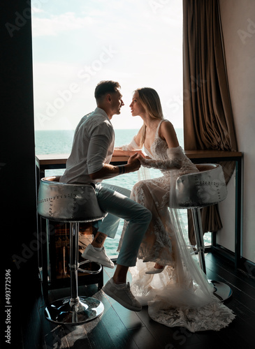 Man and woman studio shoot with decor kisses  hugs. Happy couple. Lovers bride and groom in luxury decoration. Bride and groom together. Couple hugging. Newlyweds at wedding day
