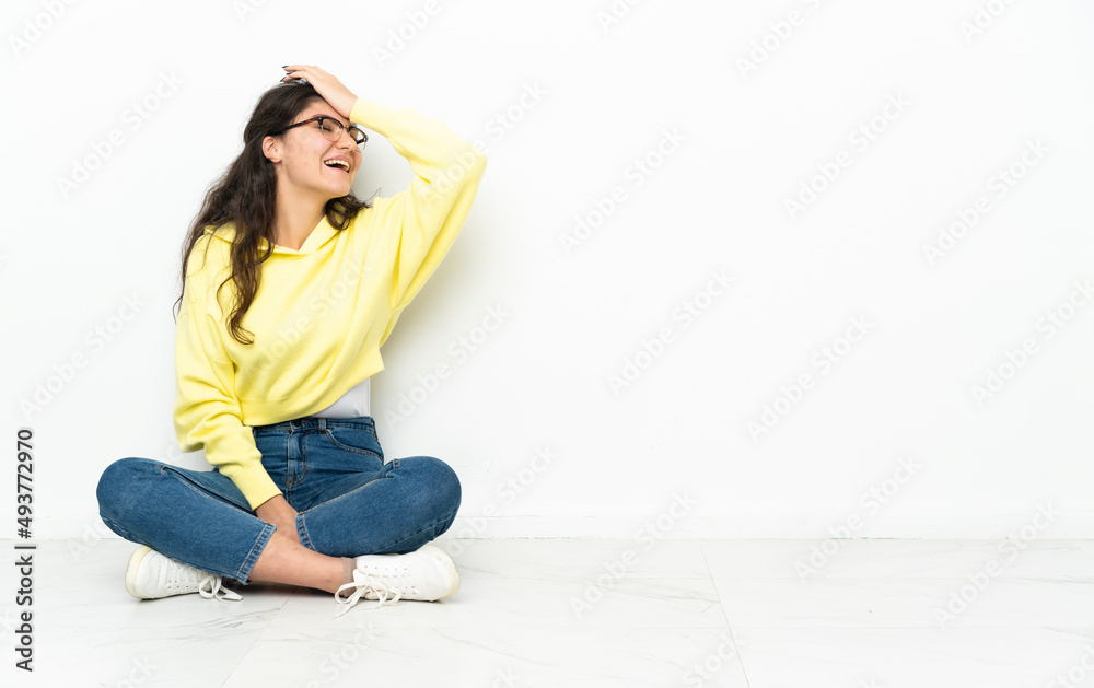 Teenager Russian girl sitting on the floor has realized something and intending the solution Teenager Russian girl sitting on the floor has realized something and intending the solution
