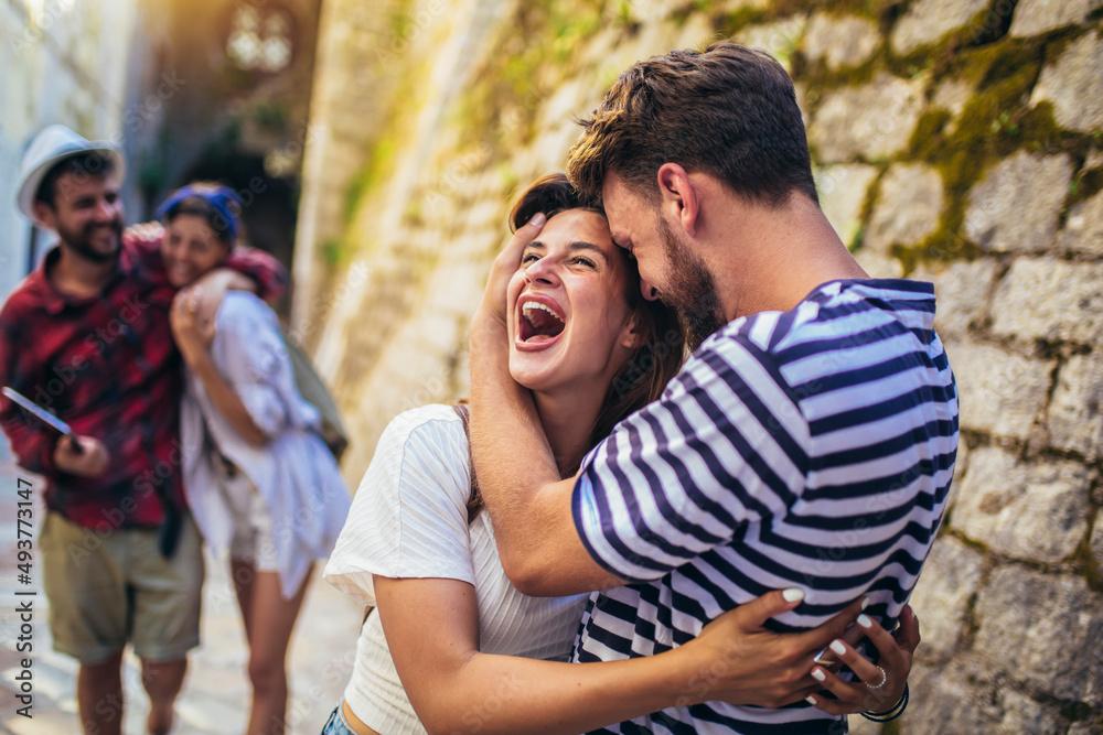 Young millennials friends walking in city old town center on summer vacation Young millennials friends walking in city old town center on summer vacation