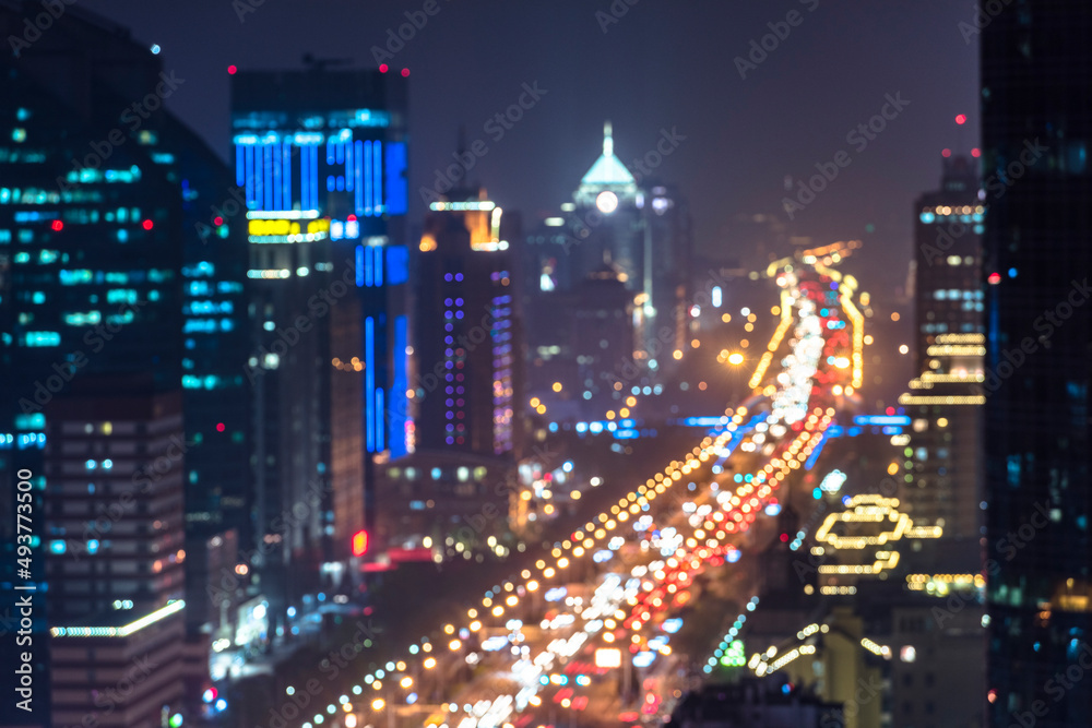 Urban overpasses with lights on at night and the urban background in the distance