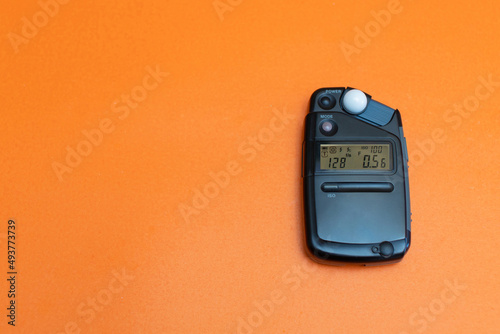 light meter for photography on the orange background copy space photo