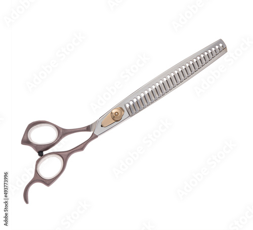 Scissors for cutting people and pets. Grooming scissors. Closed scissors on a white isolated background. Side view.