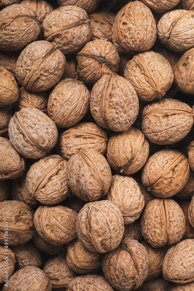 Natural walnuts in shells, can be used as a background. Top view, flat lay. Natural walnuts in shells, can be used as a background. Top view, flat lay.