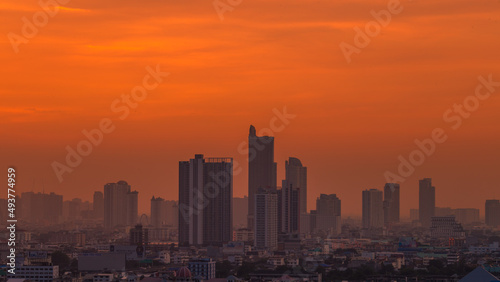 The high angle background of the city view with the secret light of the evening, blurring of night lights, showing the distribution of condominiums, dense homes in the capital community © bangprik